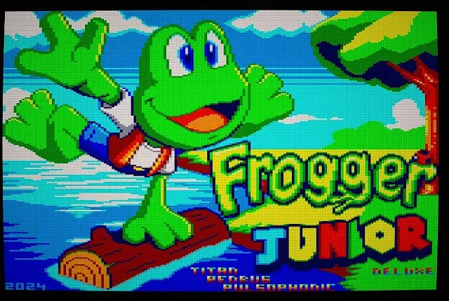 Frogger Junior gameplay showing a young frog crossing traffic toward the river