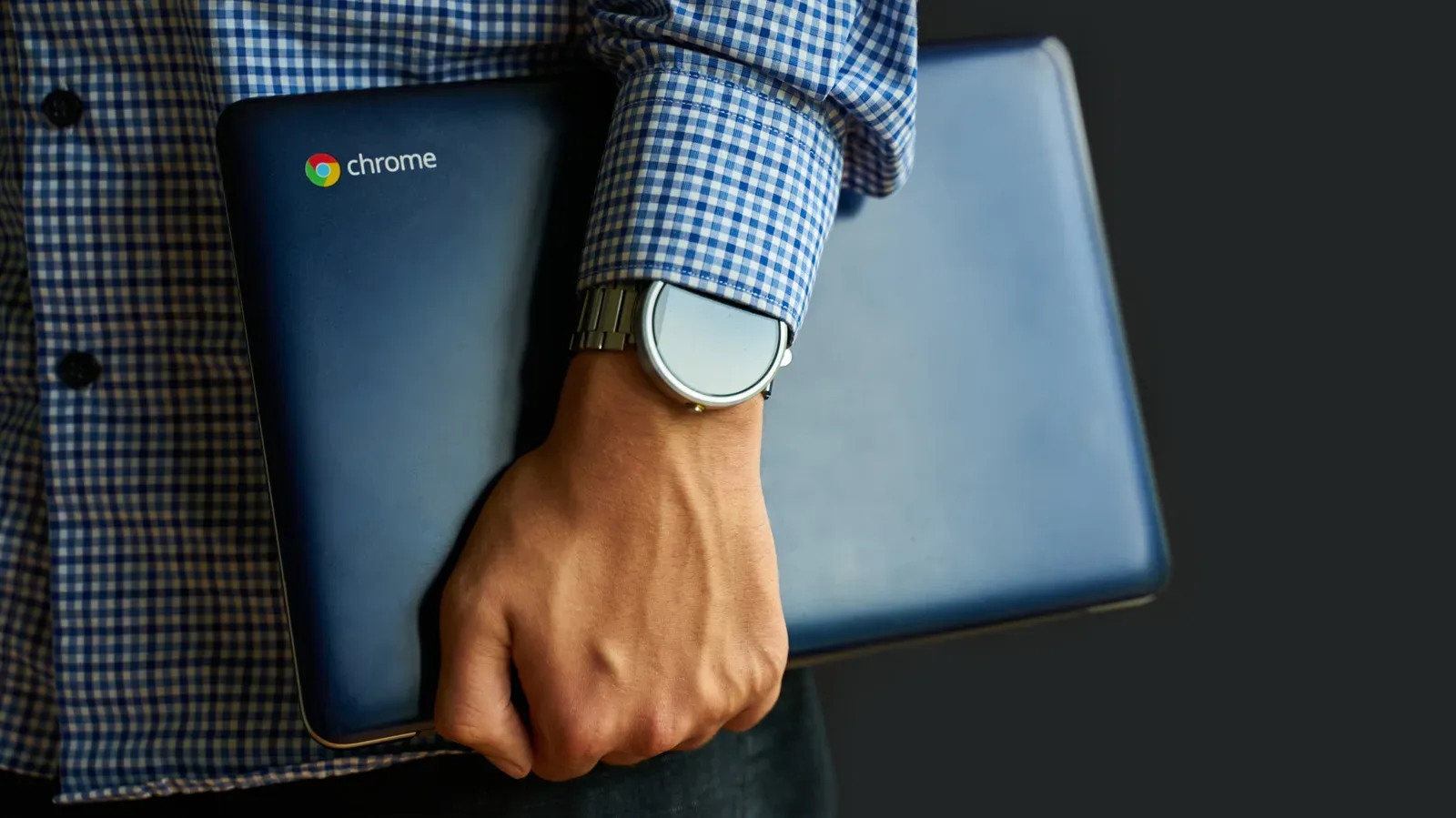 A lightweight Chromebook open on a desk with ChromeOS apps visible