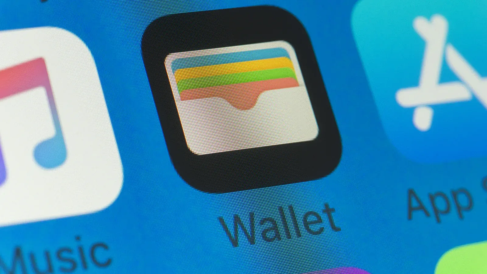 An iPhone displaying payment cards and event passes in Apple Wallet
