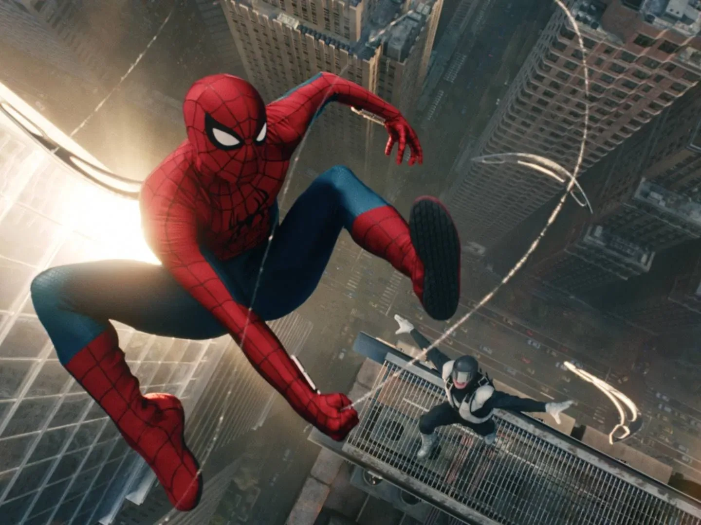 Spider-Man swinging while the villain Boomerang attacks in the sky