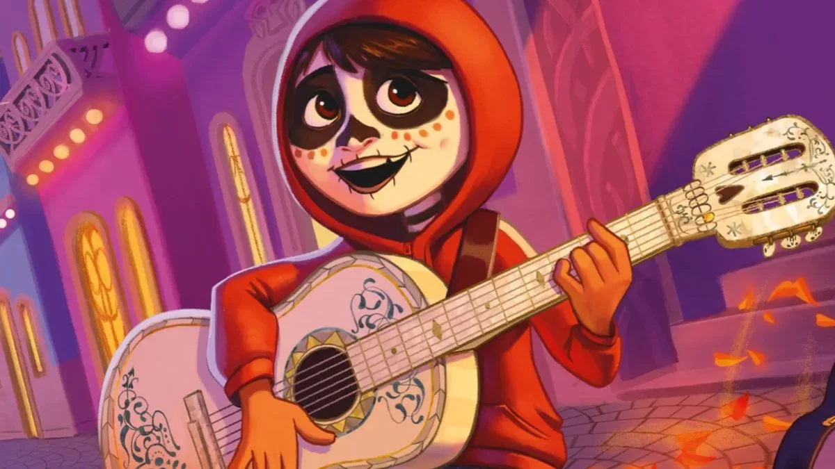 Miguel plays on a guitar on the streets while singing and smiling