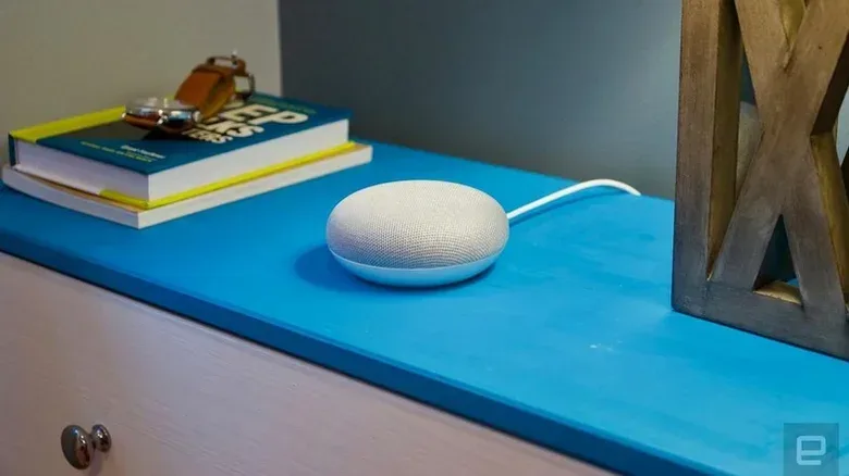 Google Nest Mini with orange pulsing LED lights after the microphone switch is turned off