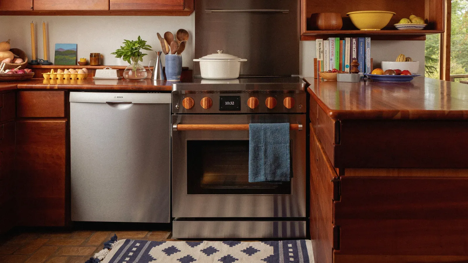 Copper Charlie induction range with a flat black cooktop and oven controls