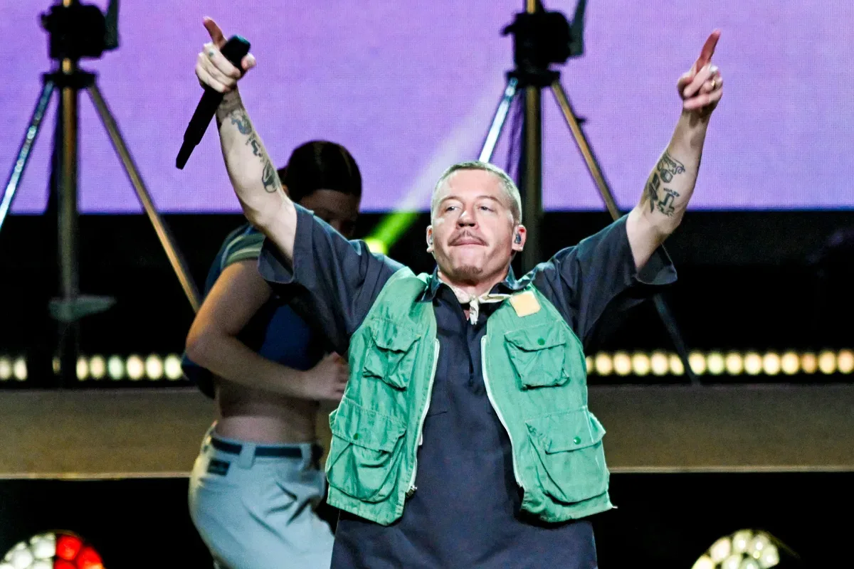 Ed Sheeran performing onstage during a stadium concert