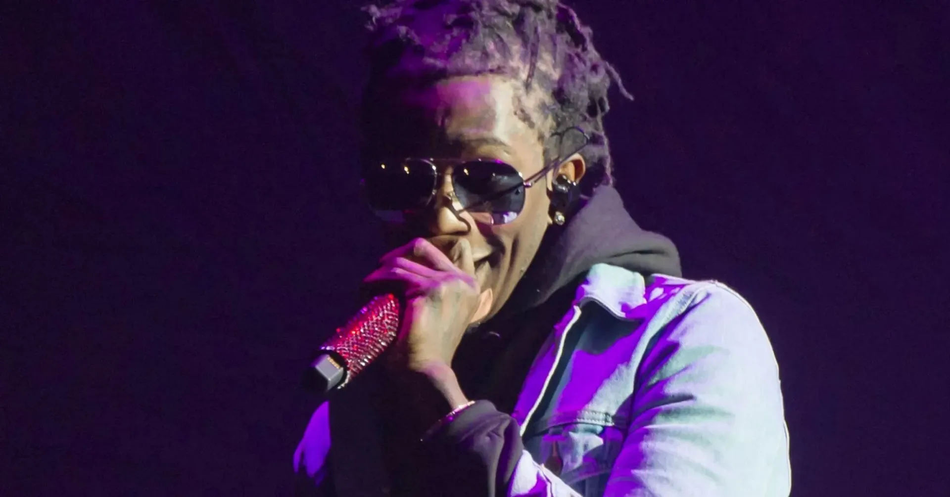 Young Thug performing onstage during a Boston tour stop