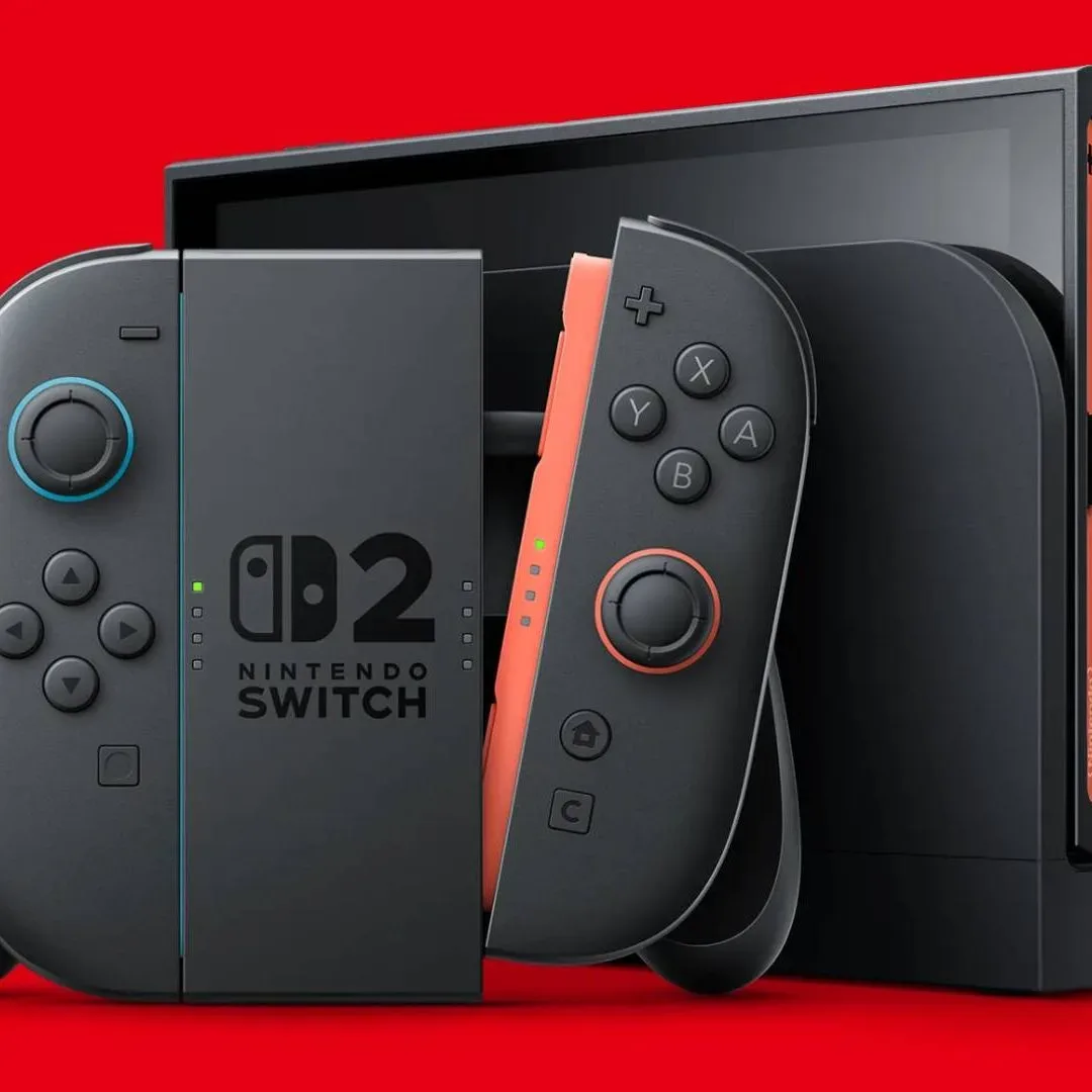 Nintendo Switch 2 in dock next to JoyCon controller grip and red backdrop