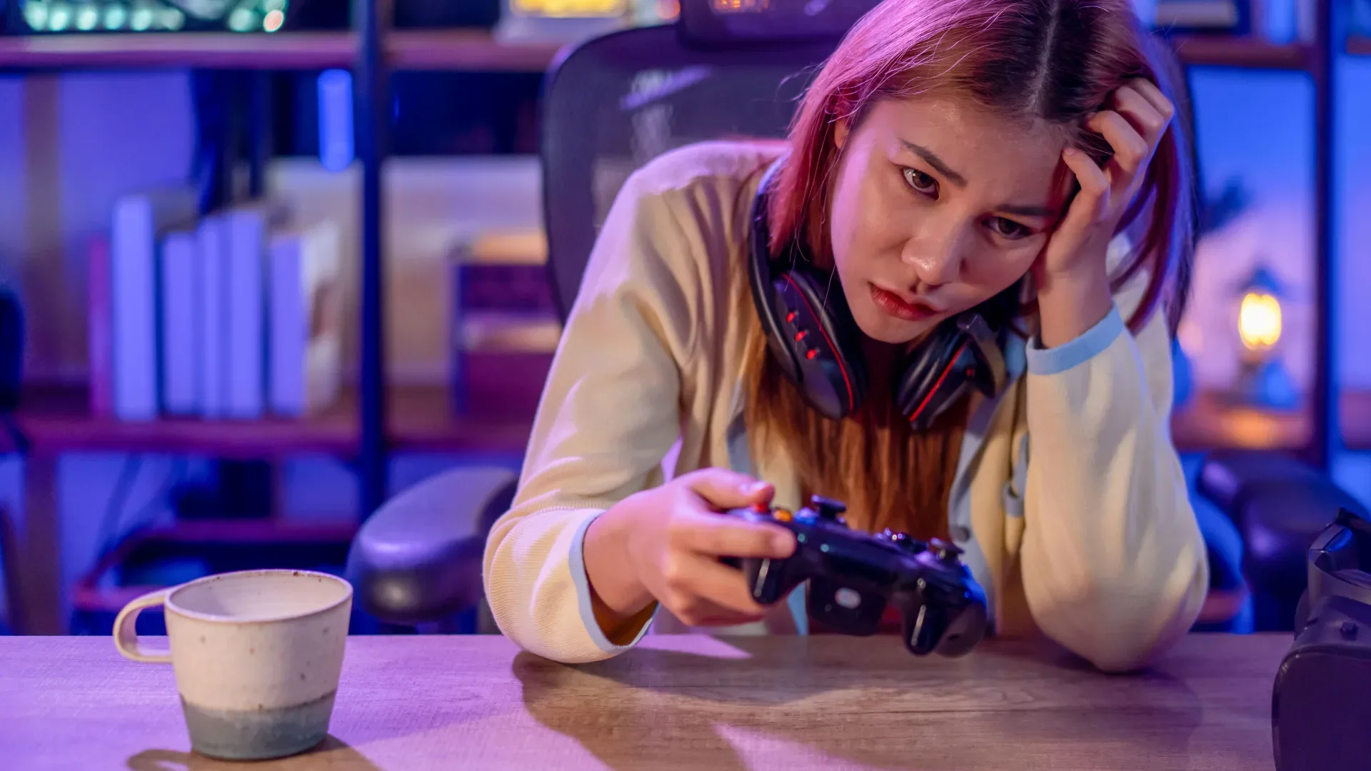 A woman using a gaming headset while playing a multiplayer game on a PC