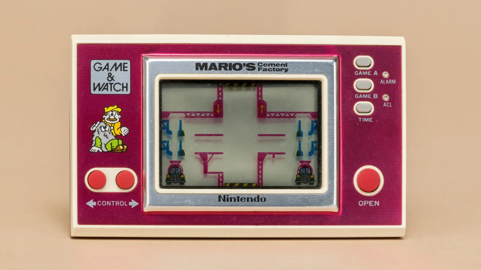 A vintage Nintendo Game & Watch handheld showing a segmented LCD game screen