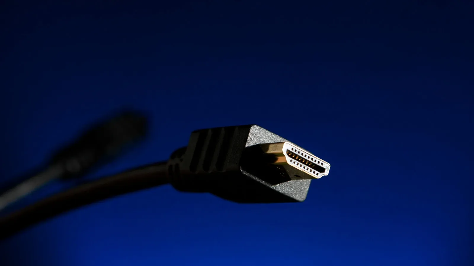 HDMI coupler joining two HDMI cables for a longer gaming display run