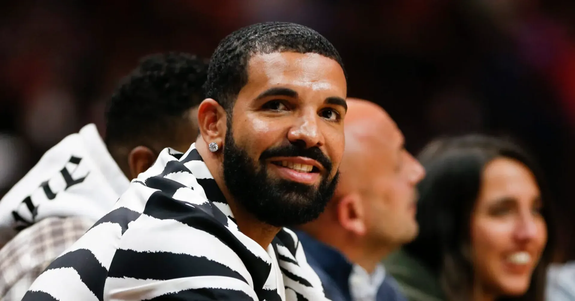 Drake in the FOMO teaser driving a neon-green speedboat