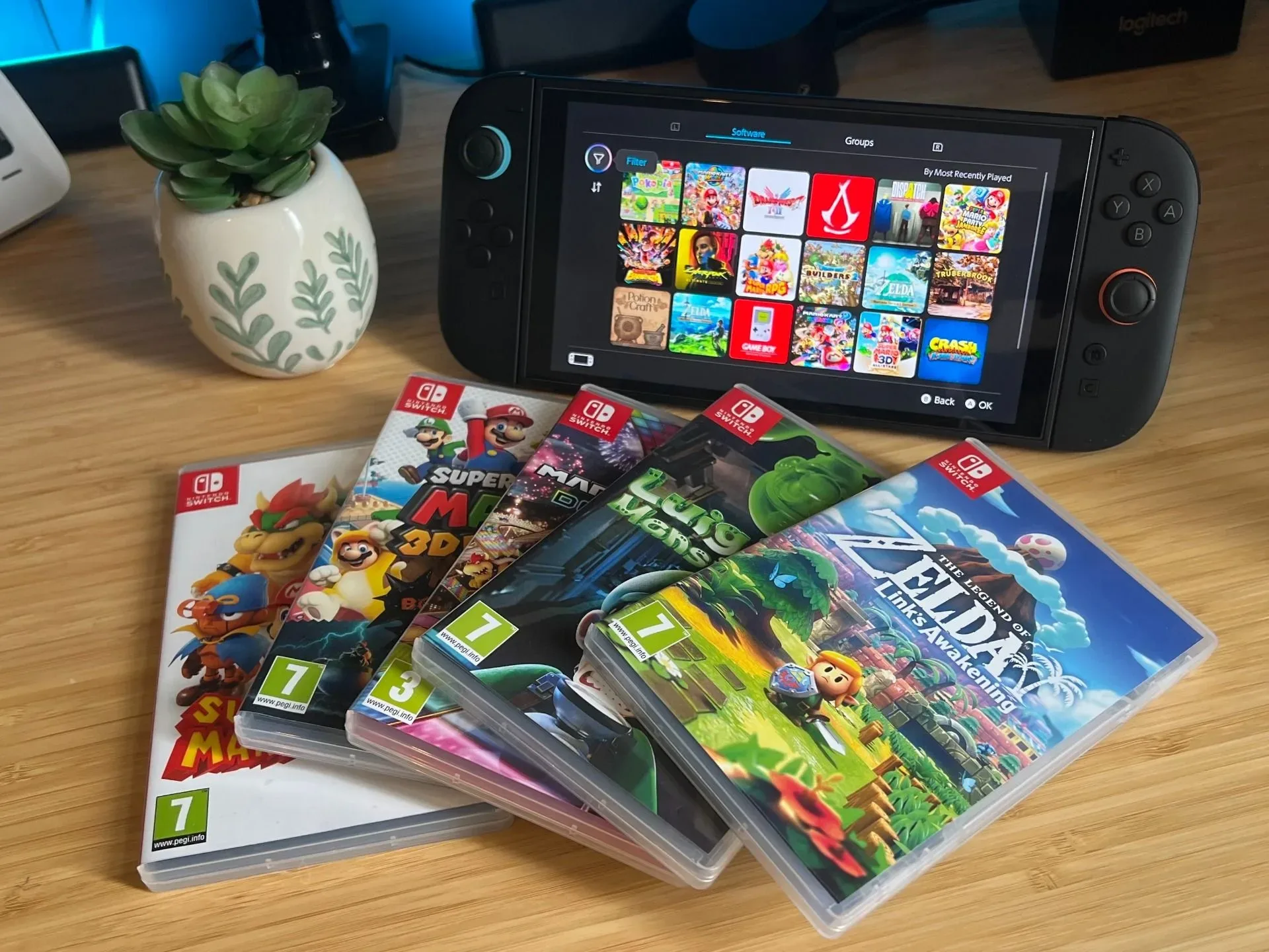 Nintendo Switch games with Switch 2 handheld on a wooden desk