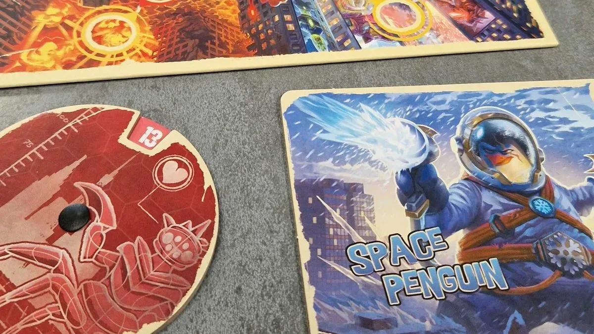 King of Tokyo: Duel Space Penguin place mat with a life counter and board beside it