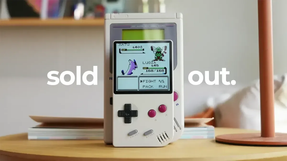 FunnyPlaying FPGB Mini handheld shown with a Game Boy cartridge