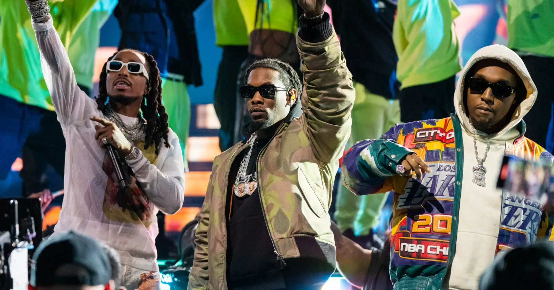 Quavo and Offset appear onstage at a listening party while “AWAY” plays