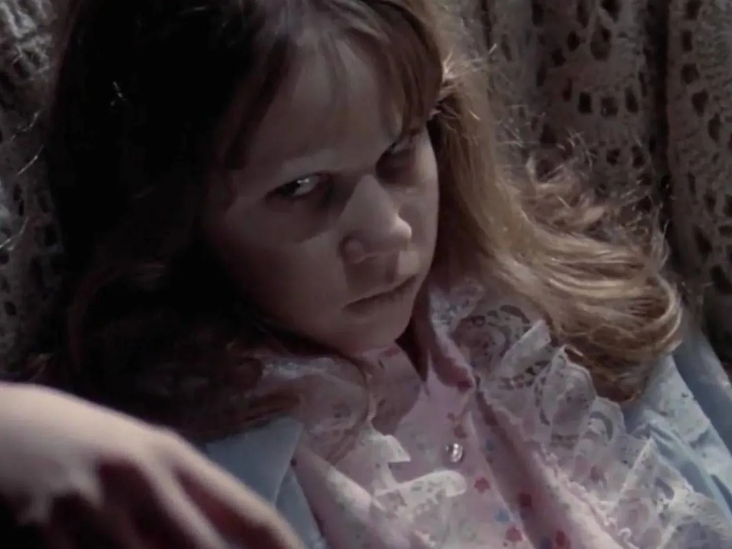 A dramatic horror-film image representing a mother and son confronting a demonic threat