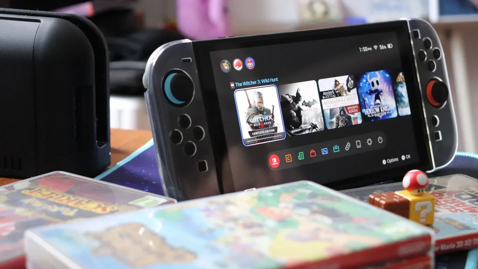 Nintendo Switch 2 seated in its dock beside a television with a black screen