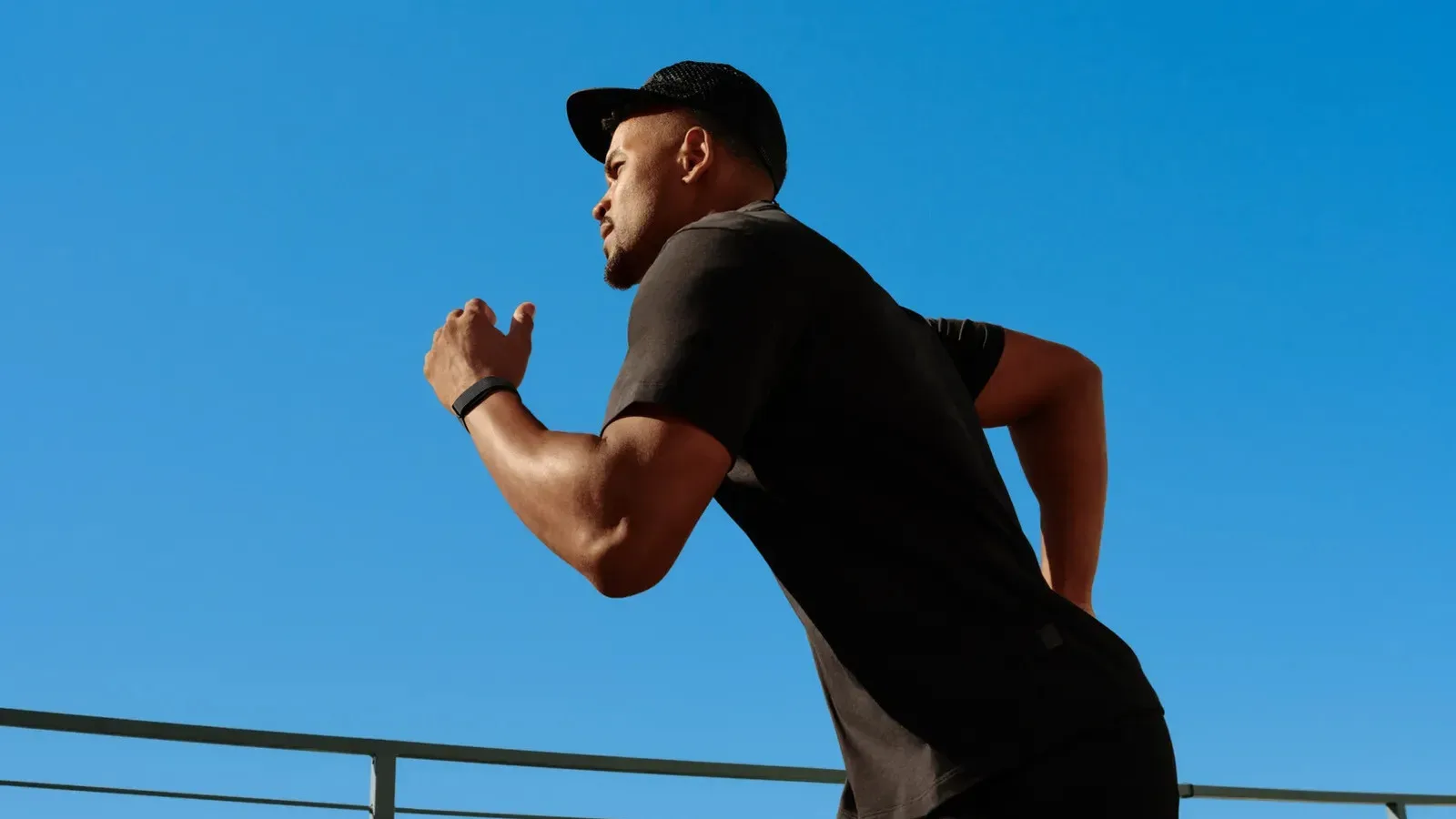 Fitbit Air and Whoop MG screenless fitness tracker bands compared on a wrist