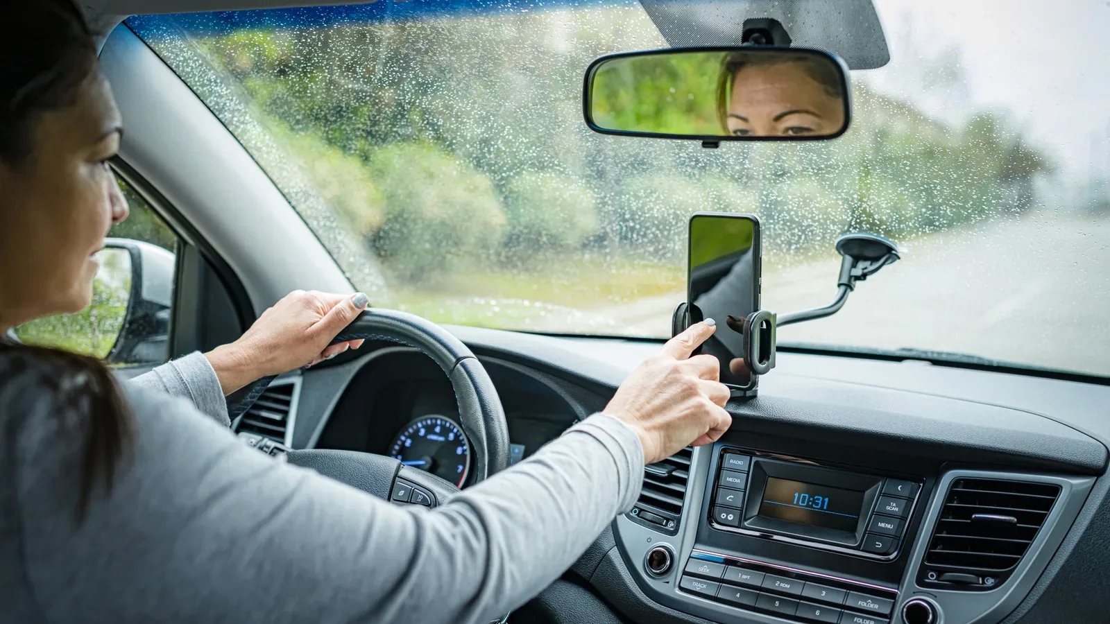 A rental car infotainment screen showing paired phone and Bluetooth settings