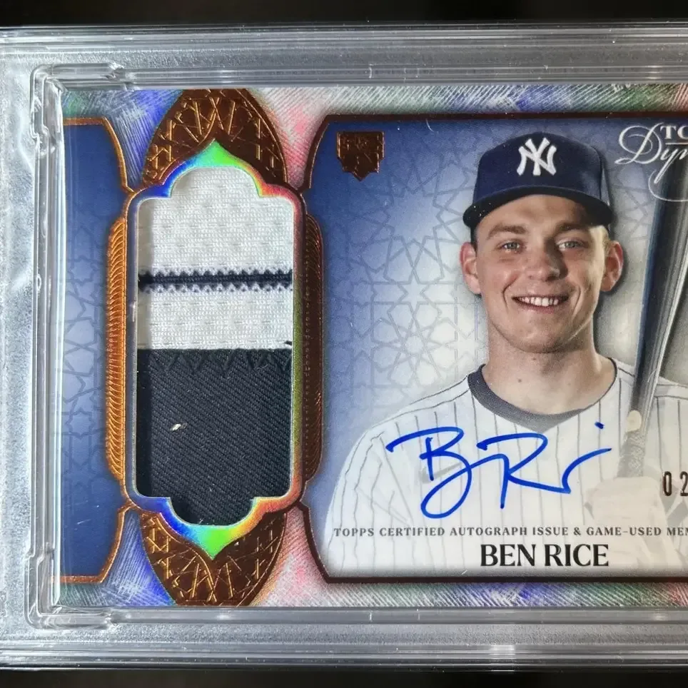 Close-up of a numbered Topps Dynasty signed patch card