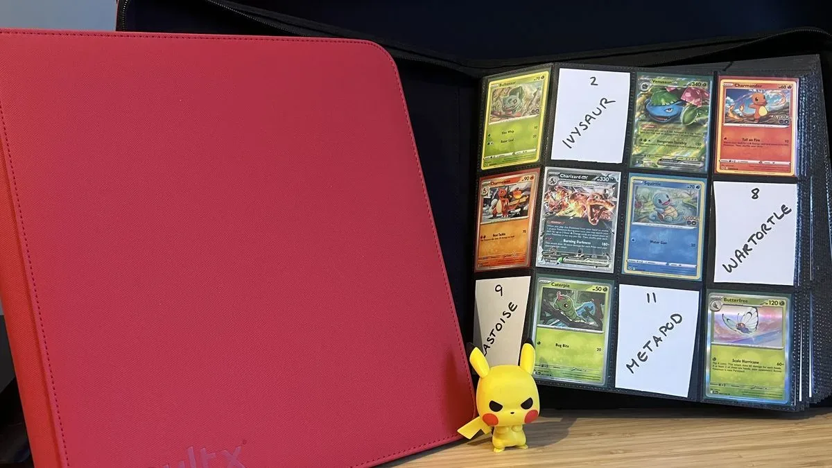 Two red Vault X card binders with Pokemon cards on show