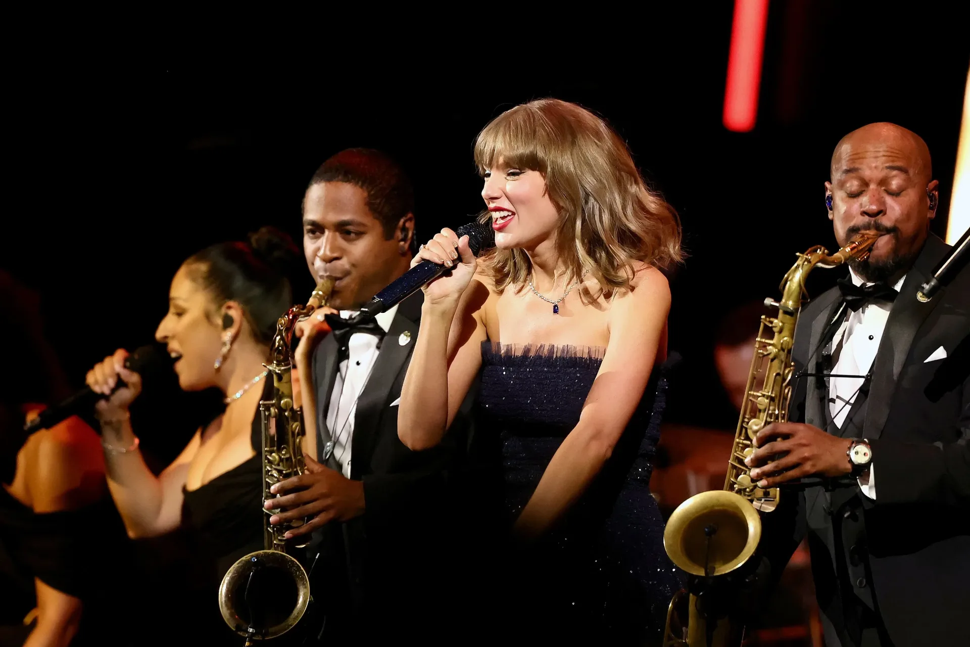 Taylor Swift performs with a full band at the Academy Museum Gala