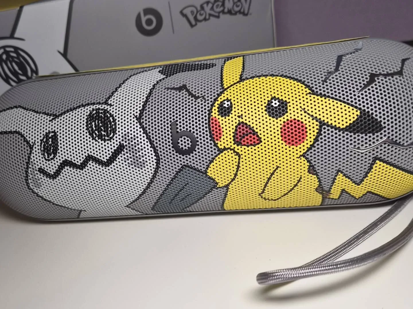 Photo of the Pokemon Beats Pill on a white gaming desk.