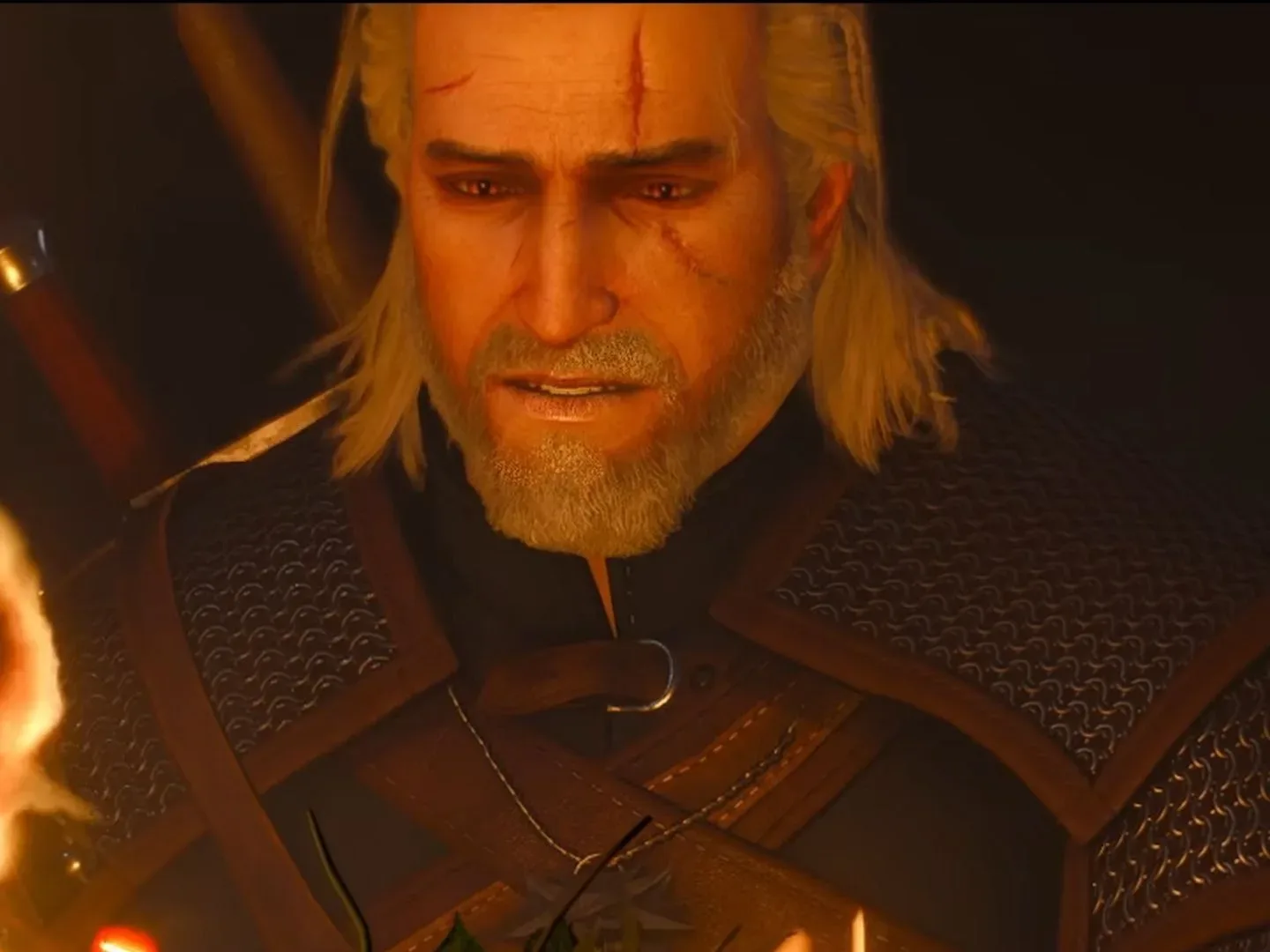 Geralt frowning, looking at a fire