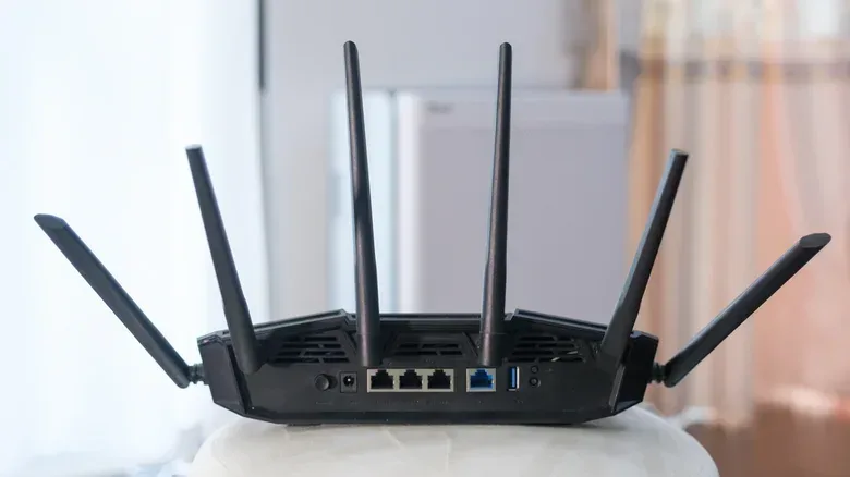 The rear of a gaming router, showing antennae along with Ethernet and USB ports.