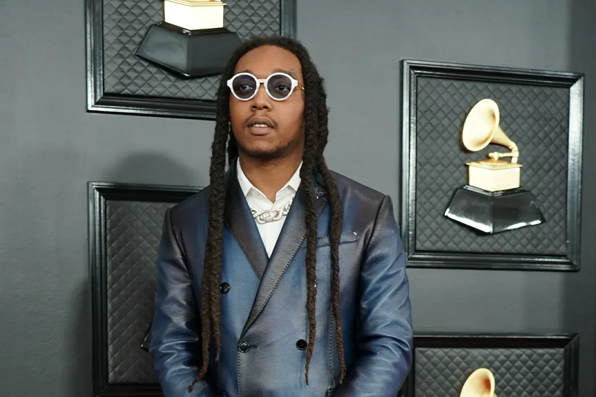 Takeoff performing onstage during a Migos appearance