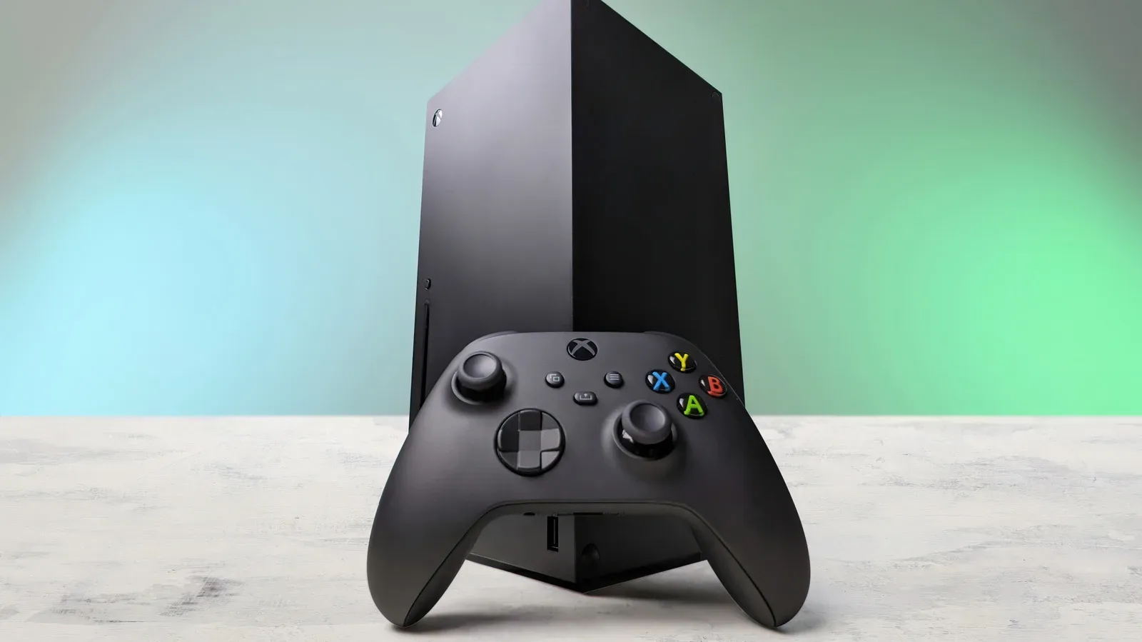 Xbox Series X beside a desktop PC tower illustrating the console versus PC cost comparison
