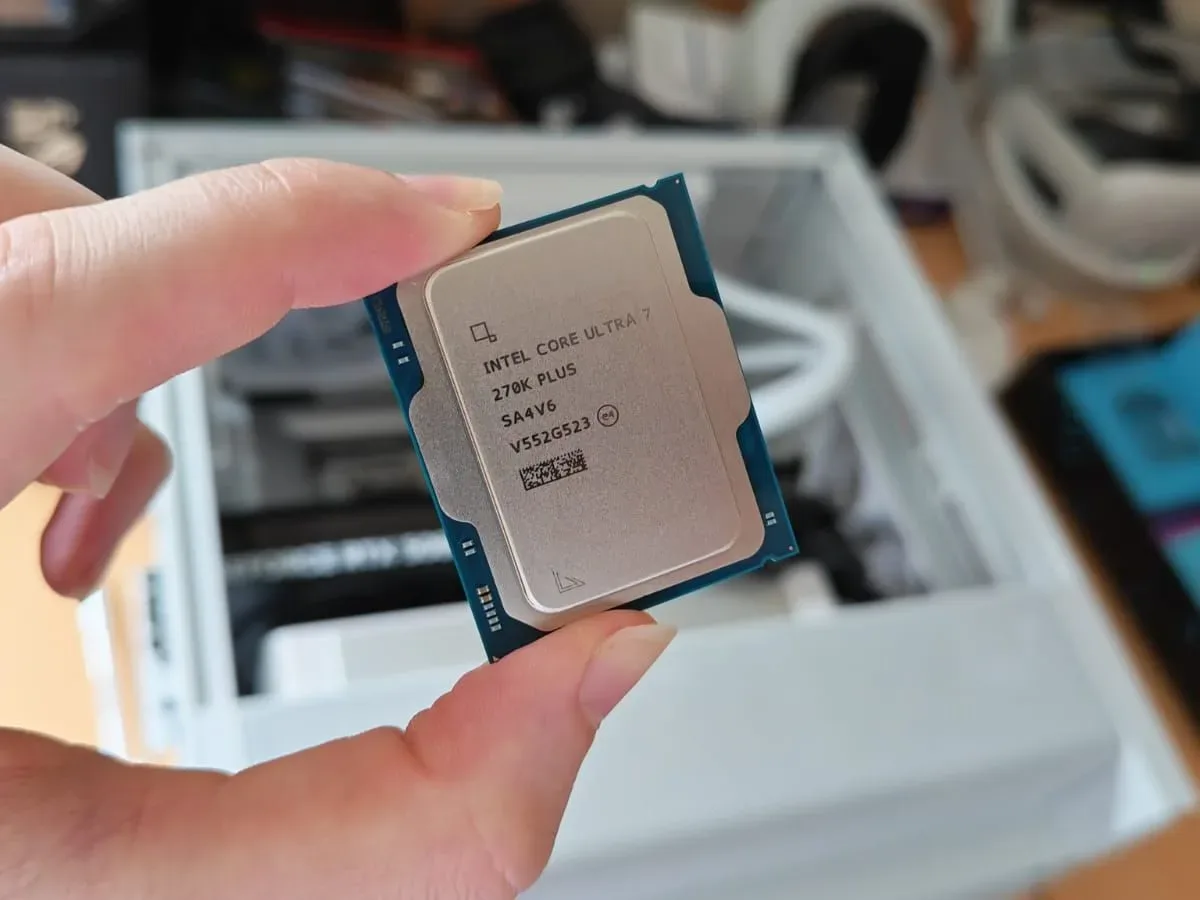 A reviewer holding the Intel Core Ultra 7 270K Plus
