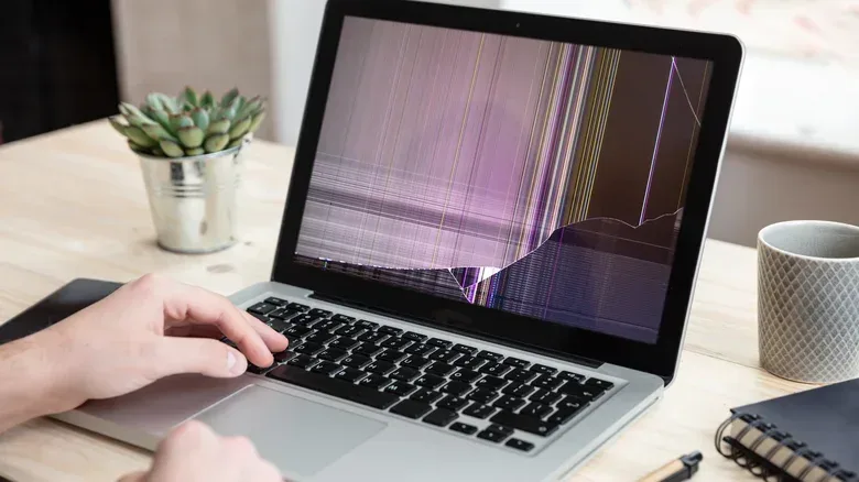 A MacBook with a keyboard cover removed before the lid is closed