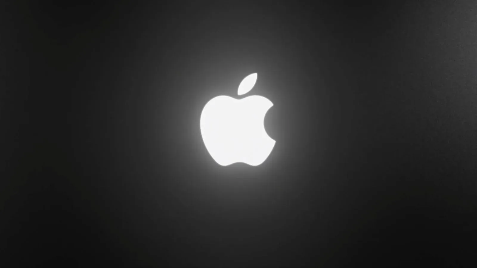Illuminated Apple logo glowing on the rear lid of a new MacBook Pro