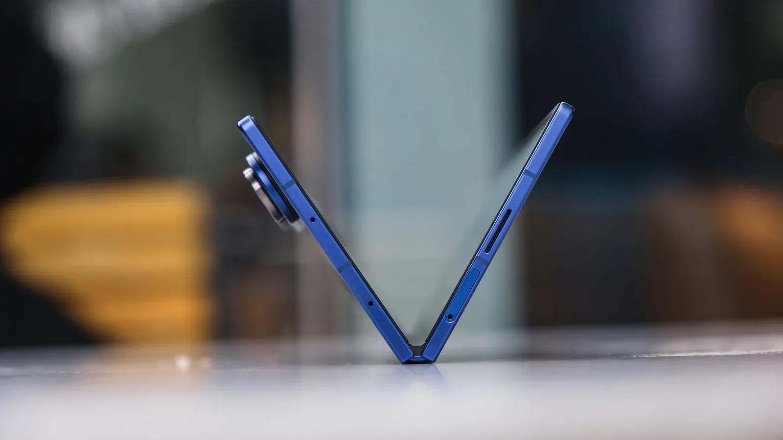 A foldable smartphone partially open with its hinge visible