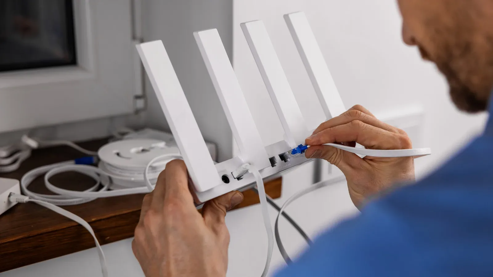 A home Wi-Fi router connected beside a modem