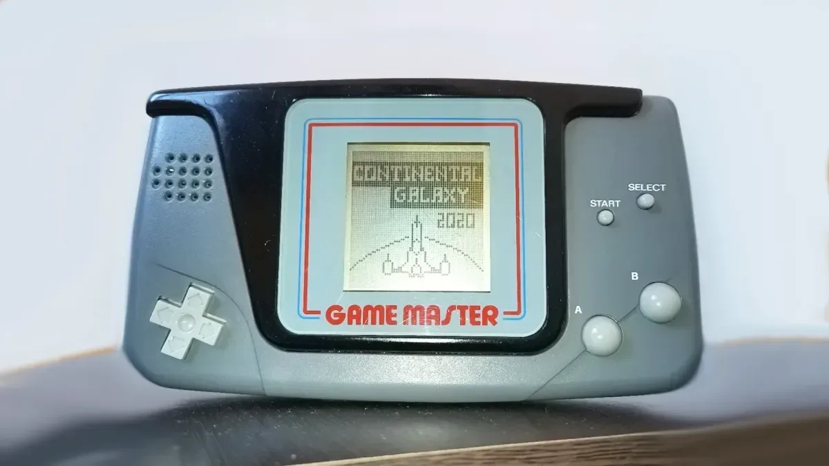 Red-and-blue Hartung Game Master handheld with grey buttons