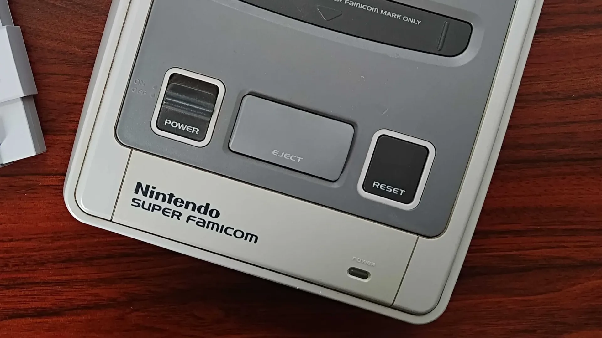 Close-up teaser of a SNES-style reset switch for Retro Remake's Codename SSNT/SuperFPGA project