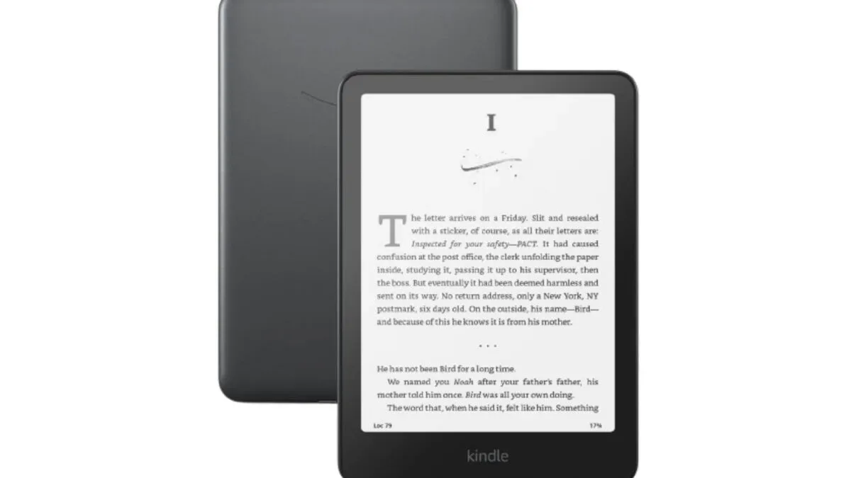 Kindle Paperwhite Signature Edition in Metallic Black beside a book