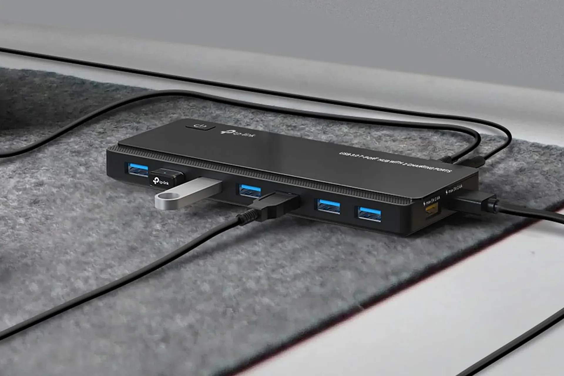 TP-Link nine-port USB hub on a PC gaming desk with connected peripherals