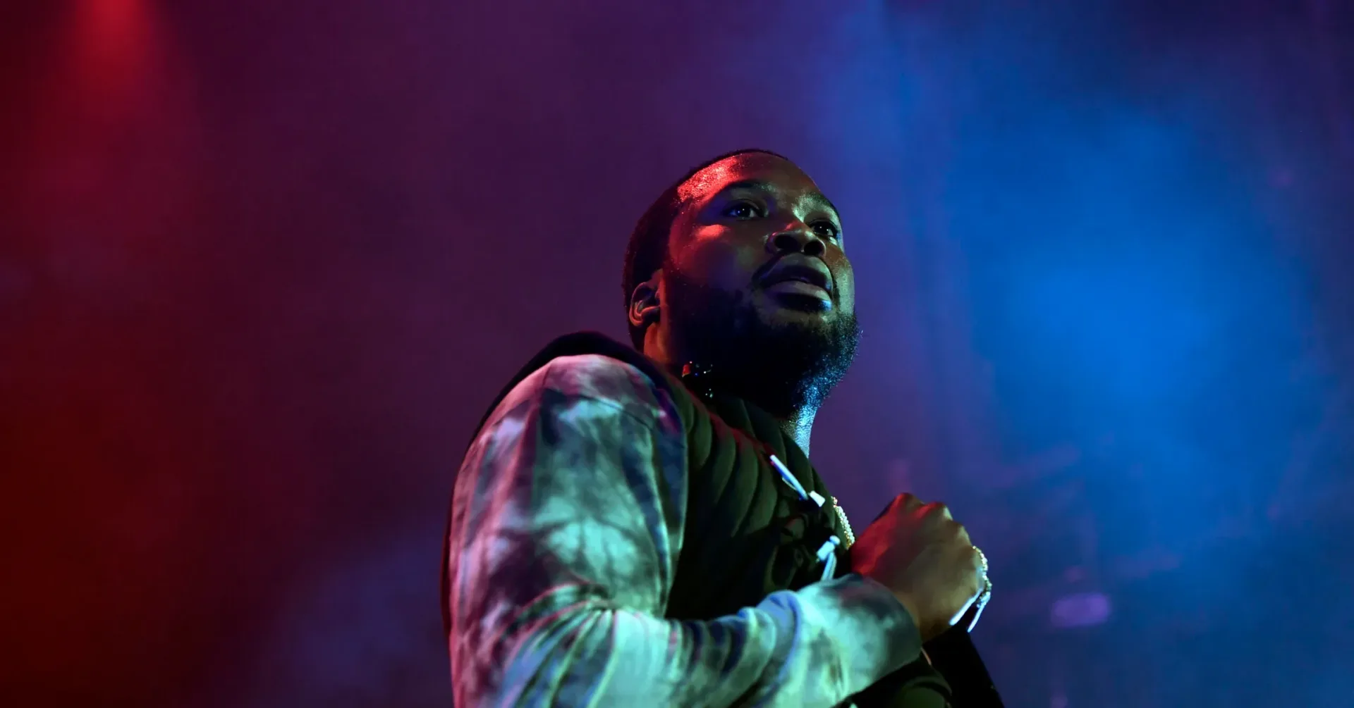 Meek Mill performing onstage during a live hip-hop concert
