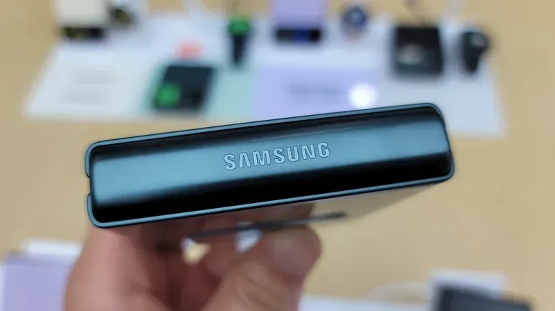 A folded smartphone resting on a clean surface without debris