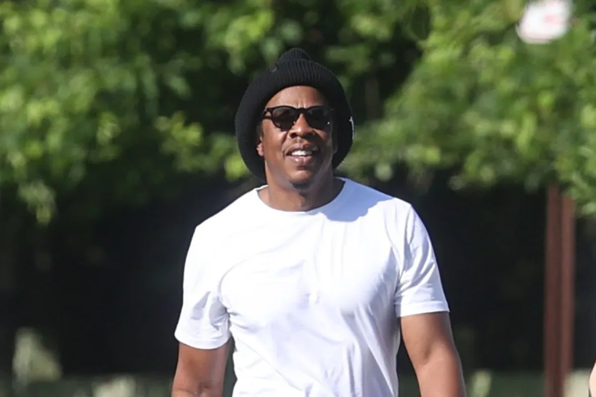 Jay-Z performing on stage under concert lighting