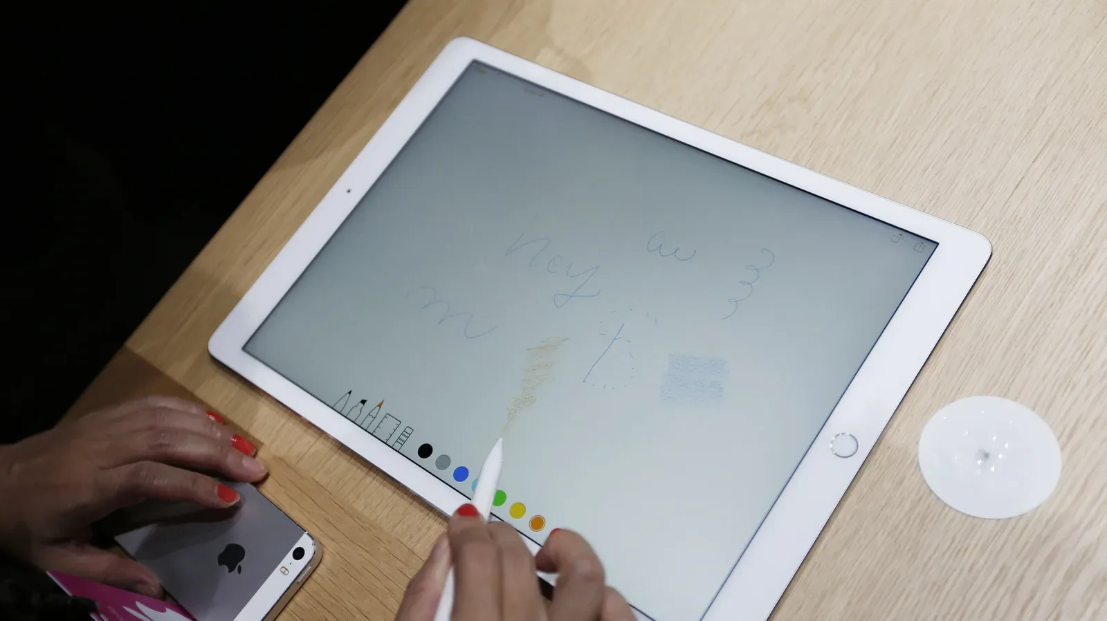 A close-up of an Apple Pencil tip showing a smooth rounded nib beside a worn, uneven replacement candidate