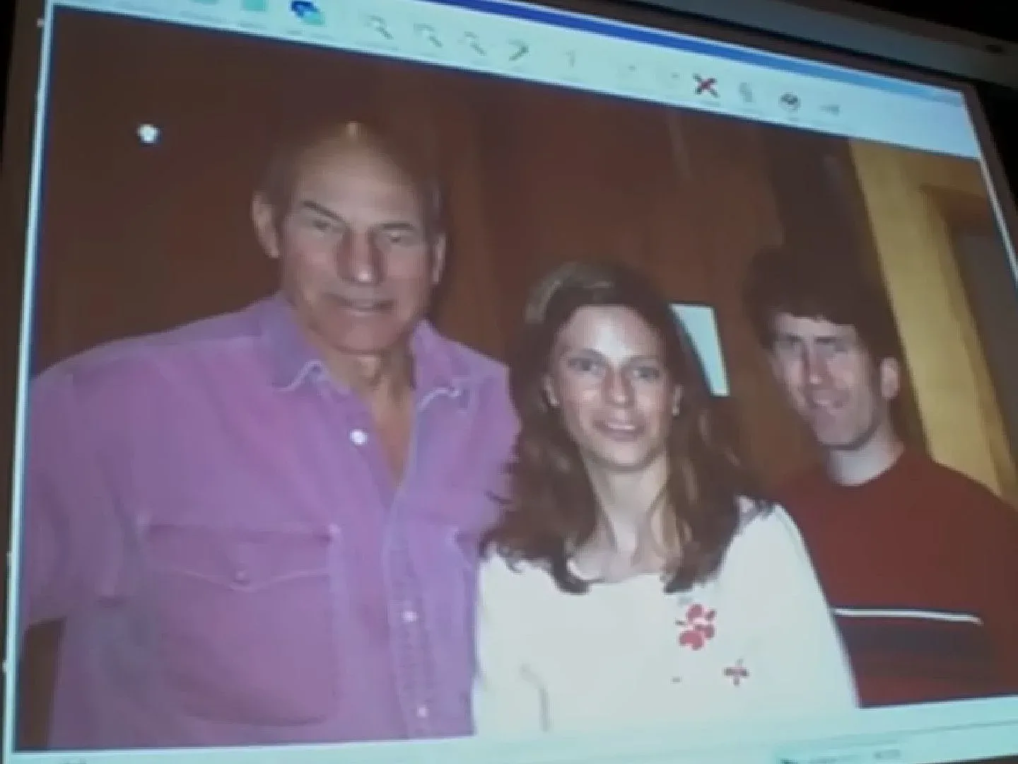 A computer screen shows a photo featuring Todd Howard, his wife, and Patrick Stewart