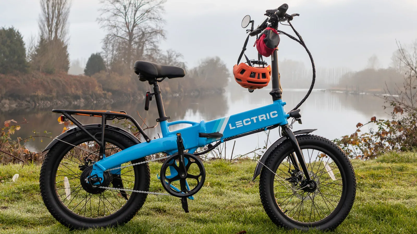 A folded electric bike beside a staircase illustrating the challenge of carrying a heavy compact e-bike