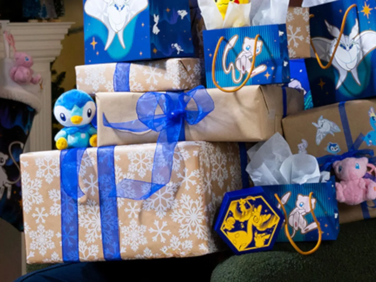 A pile of presents with Pokemon products interspersed in the pile, and a fireplace visible in the background