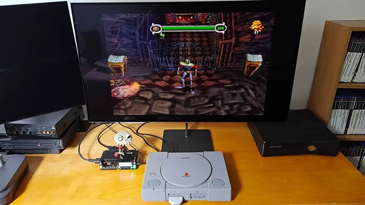 Original PlayStation console connected to Dough Spectrum Black monitor via OSSC upscaler with MediEvil gameplay on screen.