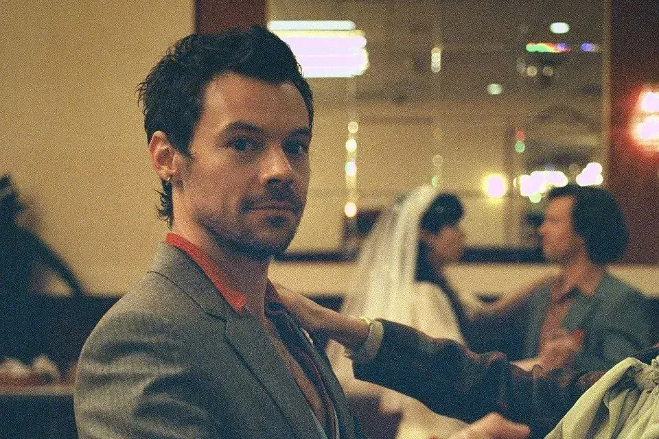 Harry Styles waltzing with a dance partner in the Coming Up Roses music video