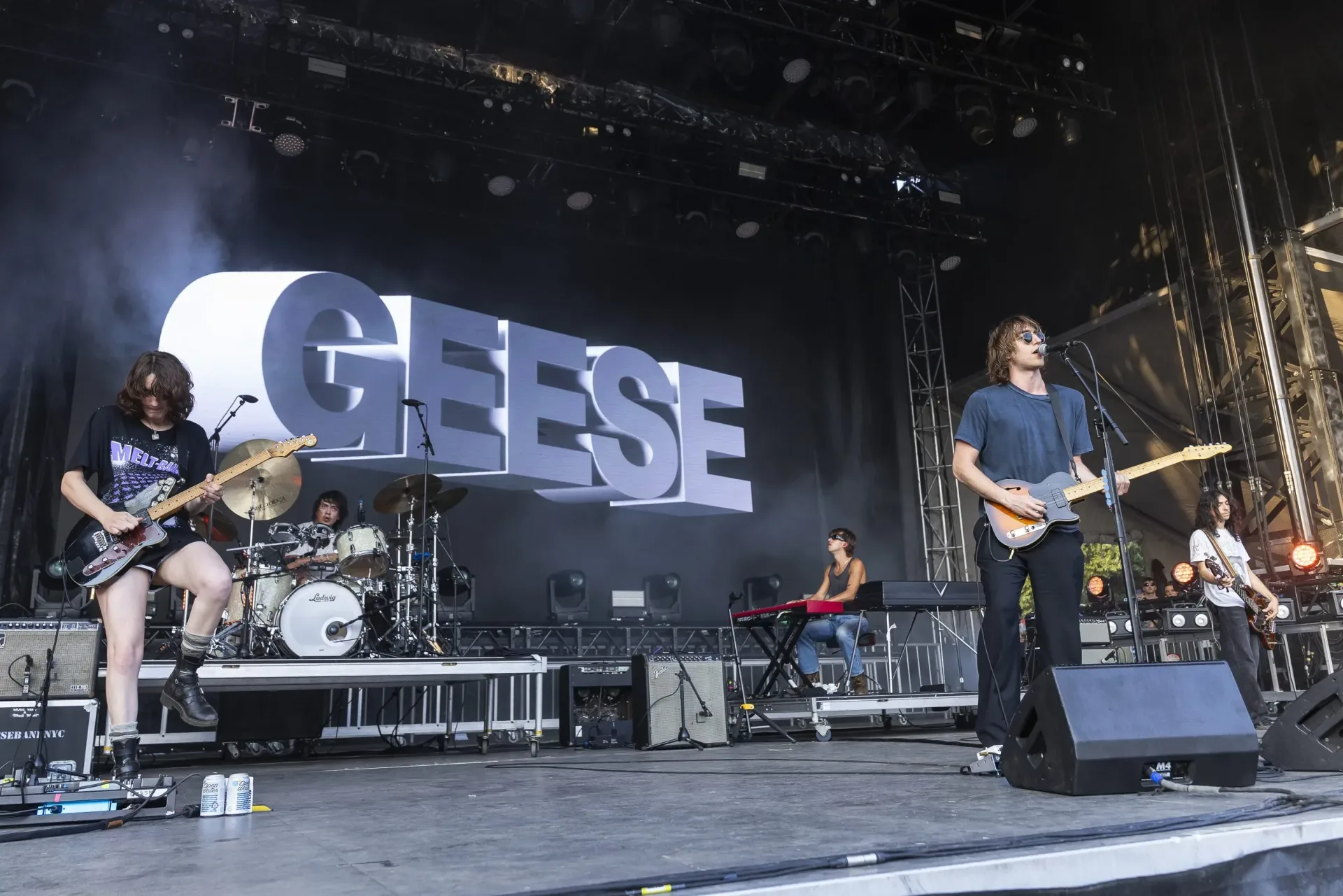 Geese performing as a four-piece rock band on stage