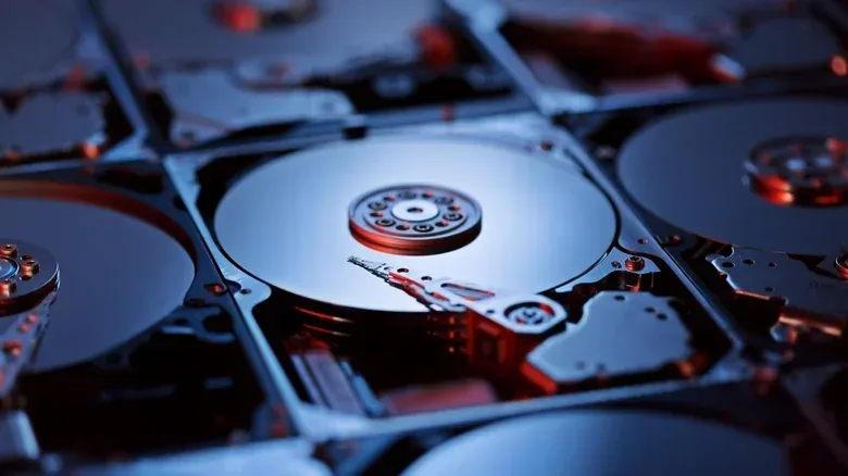 PC gamer organizing old hard drives into a RAID storage array